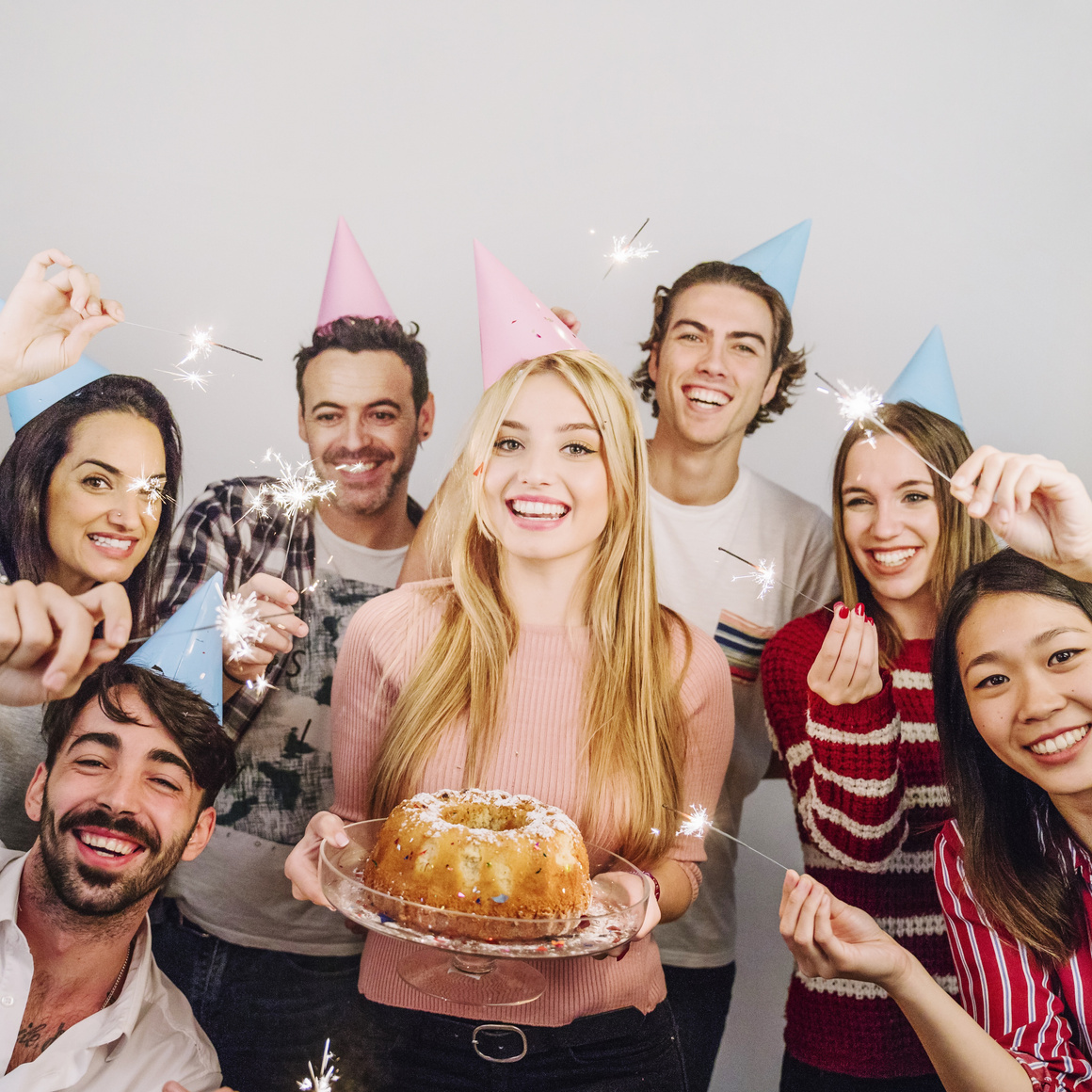 Friends Celebrating With Birthday Cake And Sparklers